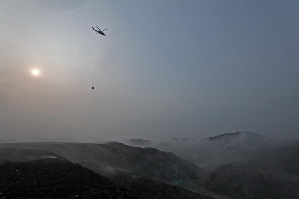 Helikopter water bombing BNPB beroperasi memadamkan kebakaran tempat pembuangan akhir (TPA) Jatiwaringin, Kecamatan Mauk, Kabupaten Tangerang, Banten, Selasa (7/6/2026). Kebakaran TPA Jatiwaringin terkendali 49%, BNPB fokus pendinginan dan mengatasi bara tersembunyi. /BNPB